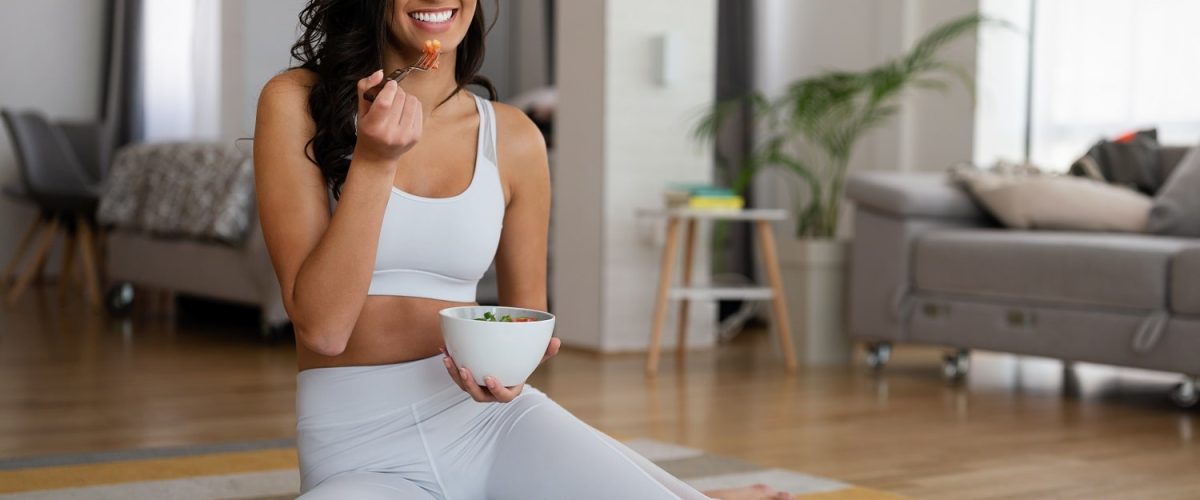 fit-woman-eating-healthy-salad-after-working-out-a-2021-08-29-10-28-08-utc-min.jpg